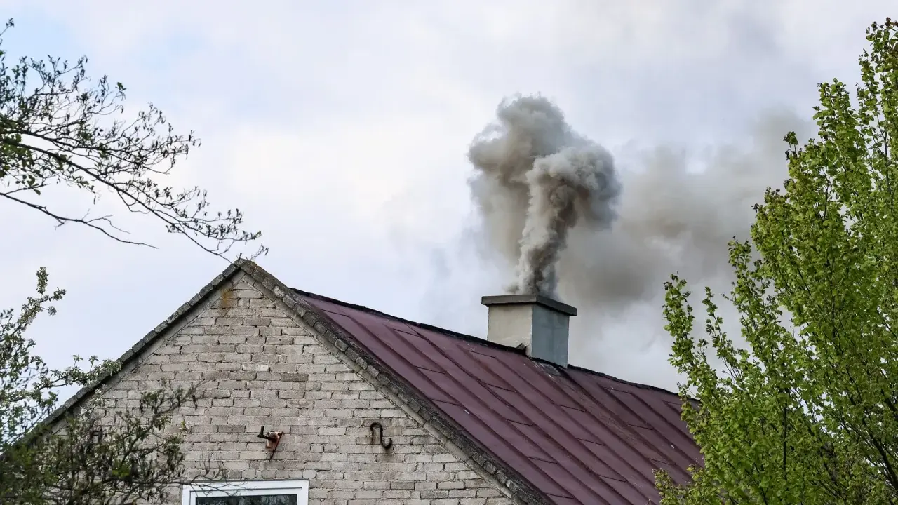 Gęsty dym z komina domu. Kto pobiera opłaty za emisję CO2, gdy takie widoki stają się codziennością?
