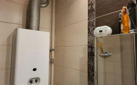Czujnik czadu zamontowany na półce nad lustrem, blisko gazowego podgrzewacza wody.